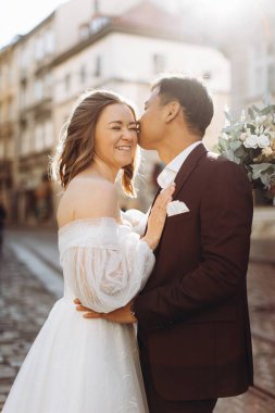 Uluslararası bir düğün çifti, Avrupalı bir gelin ve Asyalı bir damat şehirde birlikte dolaşıyorlar..