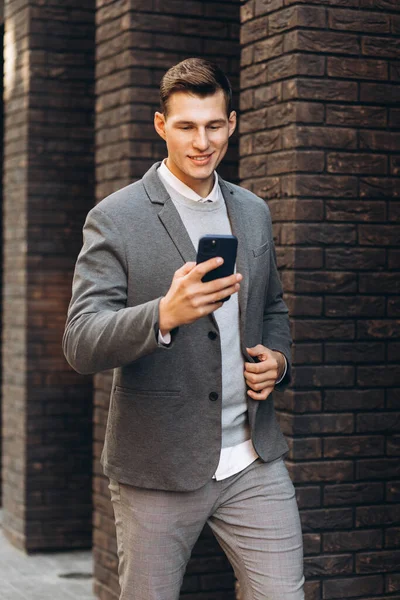 Moderní Pohledný Usměvavý Muž Kráčí Ulici Mluví Telefonu — Stock fotografie