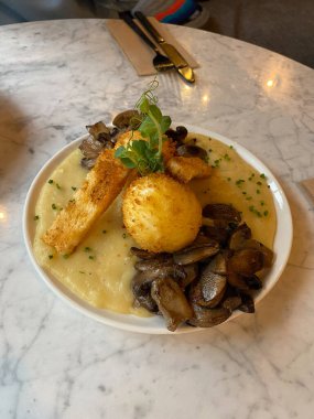Patates püresi ve mantarlı gevrek yumurta restoranda kahvaltı tabağında..