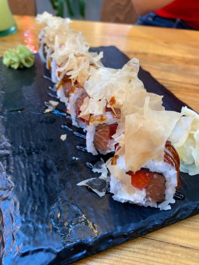 new trend close-up Philadelphia roll sushi with salmon, strawberry, avocado, cream cheese. Sushi menu. Japanese food. ready to eat.