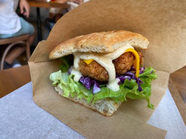 Focaccia Bread Sandwich with Fried Crispy Chicken and Mustard Sauce. Ready to Eat.