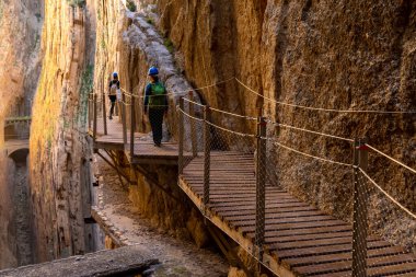El Chorro, İspanya - 22 Şubat 2022: turistler gösterişli bir kış gününde Camino del Rey 'de yürüyüş yapmayı severler.
