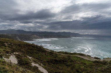 A view of the rugged cliffs and coastline at Cabo Vidio in Asturias under an expressive sky