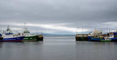 Greencastle, İrlanda - 9 Temmuz 2022: Greencastle limanı ve limanında renkli balıkçı tekneleri ve balıkçılar