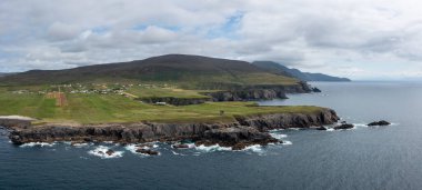 aerial panorama view of the rugged coastline of County Donegal at Malin Beg with the ruins of the Napoleonic signal tower on the cliff edge