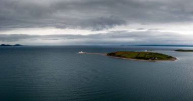 An aerial view of the Clare Island lighthouse on one of the sunken drumlin islands in Clew Bay in County Mayo of western Ireland