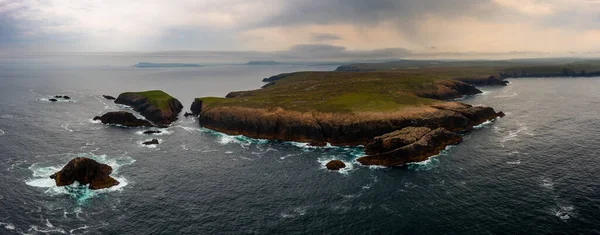 A drone panorama of the cliffs of Erris Head on the northern tip of the Mullet Peninsula in County Mayo under a stormy sky