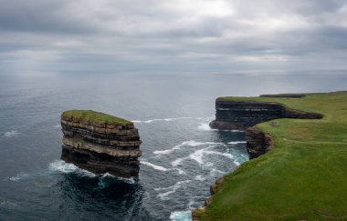 An aerial view of the Downpatrick Head sea stack and cliffs and coastline of northern County Mayo in Ireland