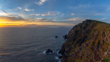 sunset over the Atlantic Ocean and the cliffs of Bray Head on Valentia Island in County Kerry of western Ireland