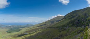 panorama landscape with the steep and winding mountain road leading to the top of Connor Pass on the Dingle Peninsula in County Kerry