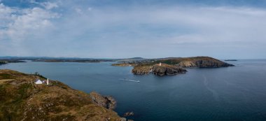 A panorama view of the entrance to the Baltimore Harbor in West Cork with teh Sherkin Island Lighthouse and the Baltimore Beacon