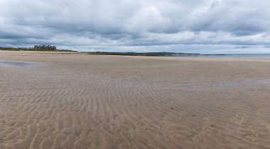 A panorama landscape of Doughmore Bay and Beach with the Trump International Golf Club hotel in the background