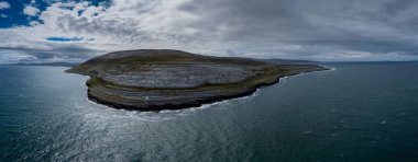 An aerial view of the Burren Coast in County Clare with the Black Head Lighthouse on the rocky point