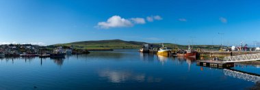 Dingle, Ireland - 7 August, 2022: panorama landscape view of the fishing port and docks at Dingle Harbor in County Kerry