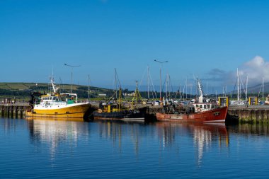 Dingle, Ireland - 7 August, 2022: colorful fishing boats on the docks in the harbor of Dingle in County Kerry