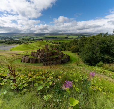 View of the multiverse stone circle with the Andromeda and Milky Way hills behind in the Crawick Multiverse