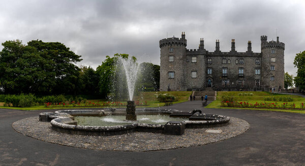 Kilkenny, Ireland - 17 August, 2022:view of Kilkenny Castle and gardens with fountain in the foreground