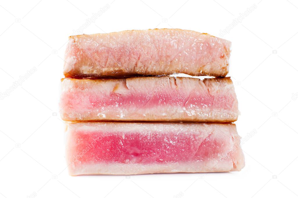 Tuna steaks of varying degrees of doneness. Rare, medium, well close-up. Isolated on white background