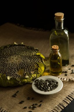 Ayçiçeği, ayçiçeği tohumu, ayçiçeği yağı, yağ üretimi, cam ayçiçeği yağı masanın üstünde, köy, ahşap zemin, bol masa örtüsü