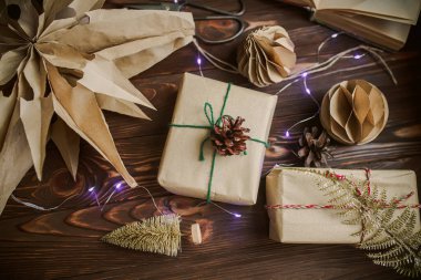 Zero waste Christmas gift. Wrapped by hand gift in New Year Eve. Delivered and balls made of craft paper. paper handmade honeycomb pom-poms. Selective focus.