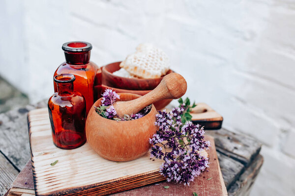 Oregano, Collect valuable flowers Origanum vulgare from moment of flowering, and start drying. Decoction of sweet marjoram and infusion in clear bottle. alternative medicine. Herbal concept