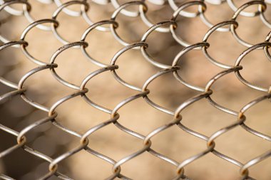 Mesh rabitz , texture of weaving mesh network link. Close up of a fence. barrier on way. metal grid close-up. rusty mesh texture.