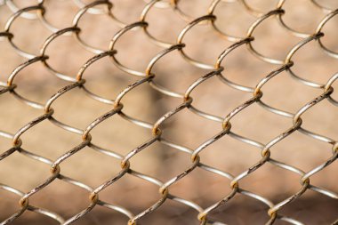 Mesh rabitz , texture of weaving mesh network link. Close up of a fence. barrier on way. metal grid close-up. rusty mesh texture.