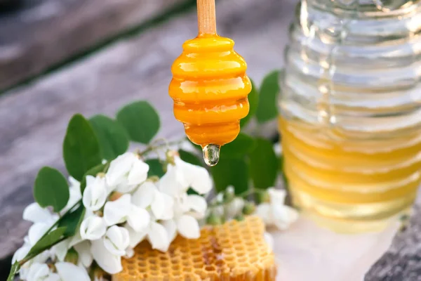 蜂蜜を瓶に入れる 木製の背景に砂糖のアカシアの蜂蜜 春の気分 選択的焦点 — ストック写真