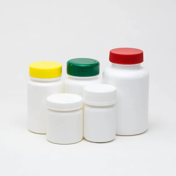 Λευκά Πλαστικά Βάζα Χαπιών Λευκό Φόντο Πολύχρωμα Καπάκια Μεμονωμένα — Φωτογραφία Αρχείου