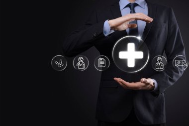 İş adamının elinde sanal ve tıbbi ağ bağlantısı simgeleri var. Covid-19 salgını insanları bilinçlendirir ve sağlık hizmetlerine dikkat çeker. Doktor, belge, ilaç, ambulans, hasta ikonu