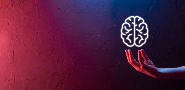 Male hand holding brain icon on neon red,blue background. Artificial intelligence Machine Learning Business Internet Technology Concept.Banner with copy space.