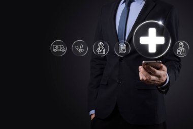 İş adamının elinde sanal ve tıbbi ağ bağlantısı simgeleri var. Covid-19 salgını insanları bilinçlendirir ve sağlık hizmetlerine dikkat çeker. Doktor, belge, ilaç, ambulans, hasta ikonu