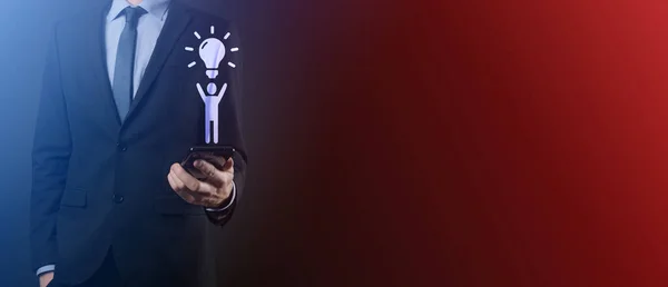 Businessman hold man icon with light bulbs, ideas of new ideas with innovative technology and creativity. concept creativity with bulbs that shine glitter