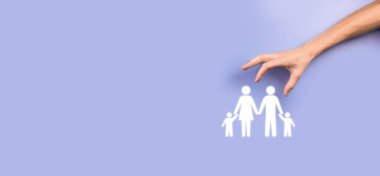 Genç aile ikonuyla el ele tutuşun. Aile hayatı sigortası, destek ve hizmet, aile politikası ve aile kavramları. Mutlu aile kavramı. Kopya alanı. Kağıt adam ailesini gösteren mançuryalı eller..
