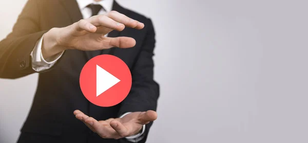 Businessman pressing, hold play button sign to start or initiate projects.Video Play Presentation. Idea for business, technology.media player button. Play icon.Go