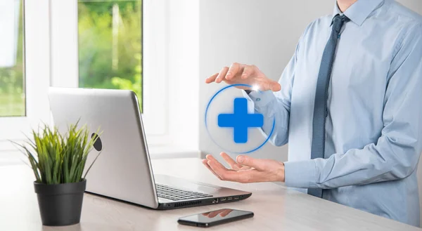 Businessman hold virtual plus medical network connection icons. Covid-19 pandemic develop people awareness and spread attention on their healthcare