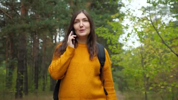 森の中を歩くスマートフォンのバックパックトークでハイカー — ストック動画
