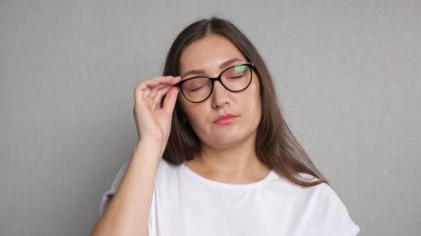 Mujer cansada se quita las gafas de vista y frota los ojos — Vídeo de stock