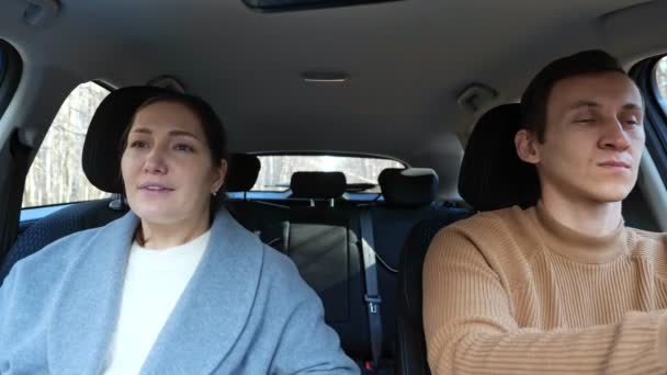 Man and woman listen to music and dance sitting in car — Stock Video