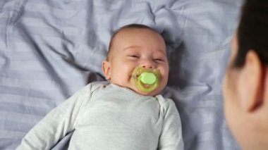 Genç anne, oğluyla oynar sahte bir gülümsemeyle oğul yapar.