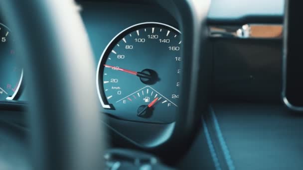 Red arrow on dashboard speedometer shows speed increase — Stockvideo