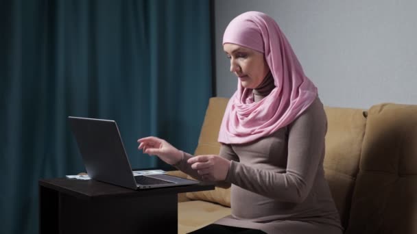 Embarazada musulmana divide los ingresos preparándose para el parto — Vídeos de Stock
