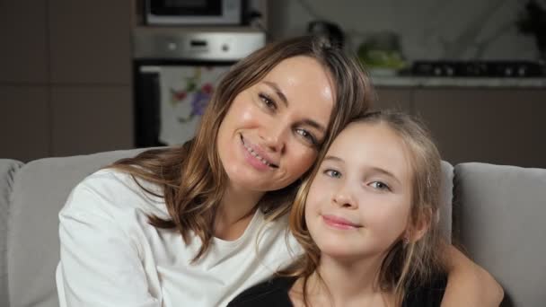 Mother and daughter smile widely looking in camera at home — Stock Video