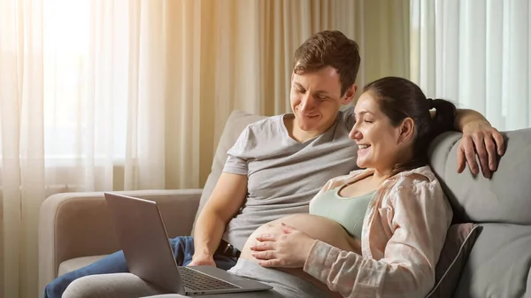 Husband and wife do online shopping for future baby hugging — Stock Photo, Image
