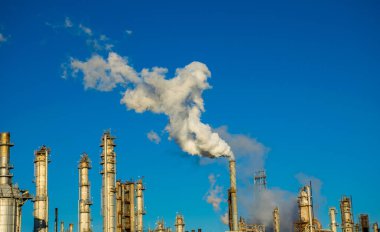 smoke stacks emitting carbon pollution into the sky causing climate change