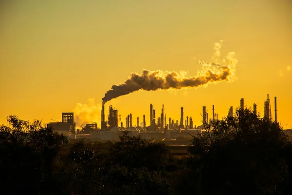 smoke stacks emitting carbon pollution into the sky causing climate change