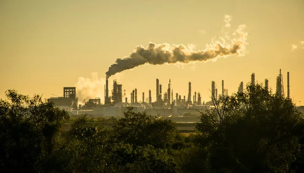 smoke stacks emitting carbon pollution into the sky causing climate change