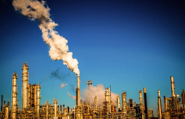 smoke stacks emitting carbon pollution into the sky causing climate change