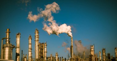 smoke stacks emitting carbon pollution into the sky causing climate change