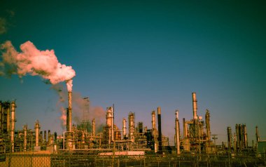 smoke stacks emitting carbon pollution into the sky causing climate change